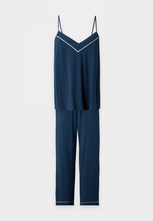 Ensemble de pyjama bleu foncé sans manches avec fines bretelles, passepoil blanc sur le haut en V et les ourlets du pantalon, et pantalon ample.