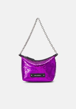 Purple sequined handbag with a rounded shape, silver chain strap, and a black logo patch. Zipper closure at the top.