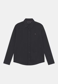 Camicia nera a maniche lunghe con bottoni, realizzata in tessuto morbido. Il colletto classico, bottoni frontali e dettaglio logo piccolo sul petto.