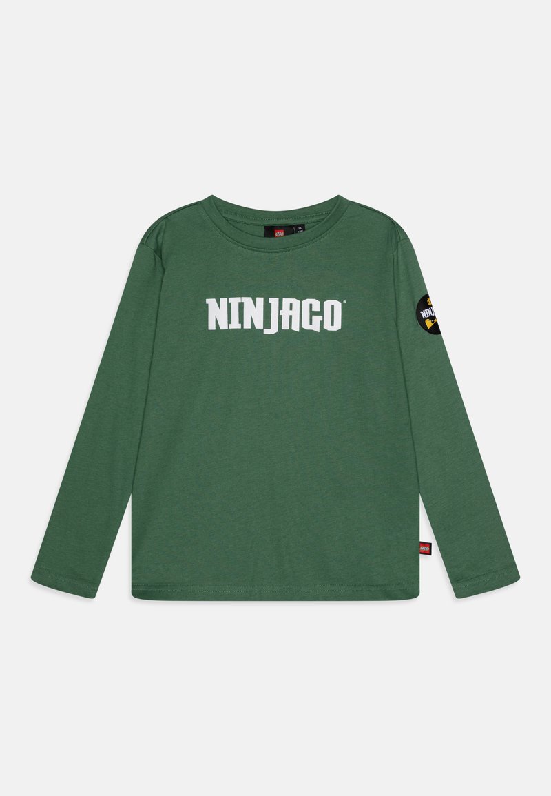 Green long-sleeve t-shirt made from soft cotton, featuring "NINJAGO" in bold white letters and a circular logo patch on the left sleeve.