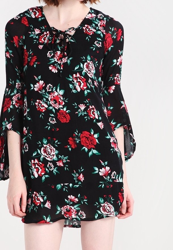 Musta kukallinen mekko, joka esittelee punaisia ja valkoisia ruusuja, solmittavan kaula-aukon ja kellohihat. Valmistettu kevyestä kankaasta, jossa on löysä istuvuus.