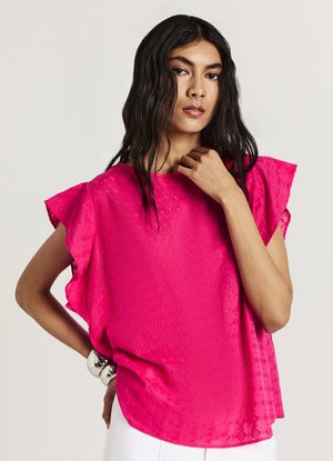 Blouse fuchsia à manches courtes avec un motif floral texturé et des accents à volants sur les épaules. Tissu doux, coupe décontractée, ourlet arrondi.