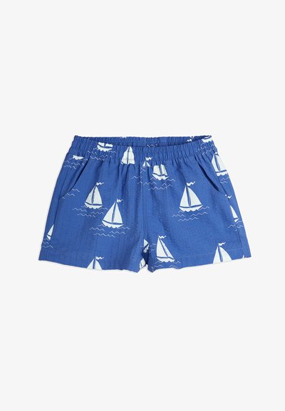 Blue shorts with a textured finish, featuring a white sailboat pattern and waves. Elastic waistband, two side pockets.