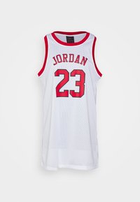 Vit baskettröja med röda detaljer, med "JORDAN" och nummer "23" i röda bokstäver. Tillverkad av meshmaterial med en lös passform.
