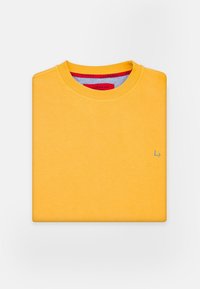 Żółta bluza z okrągłym dekoltem, z małym szarym logo z przodu oraz kontrastową czerwoną metką wewnętrzną przy dekolcie. Miękka faktura.