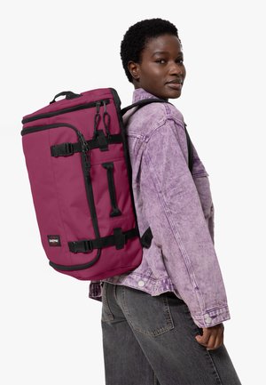 Maroon backpack with black accents, featuring adjustable straps, multiple compartments, and hardware details. Made of durable, textured material.