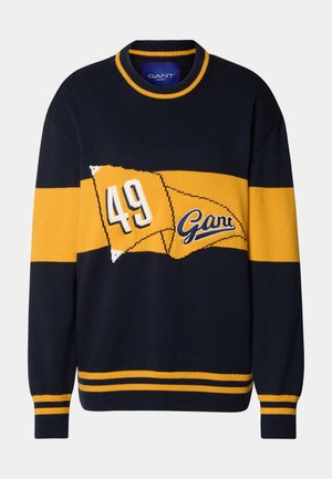 Knitted navy sweater with yellow stripes and a large embroidered "49" and "Gant" logo. Features ribbed cuffs and neckline for texture.