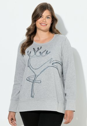 Sudadera gris de manga larga con escote redondeado, que presenta un diseño abstracto de reno en negro. Tela suave y corte relajado.