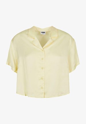 Hübsche Bluse mit kurzen Ärmeln und Kragen aus einem weichen, hellgelben Stoff. Mit Knopfverschluss vorne und einer entspannten, cropped Passform.