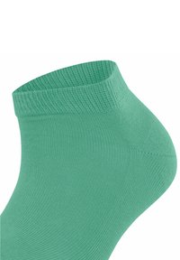 Jasnozielona skarpetka za kostkę o żebrowanej strukturze i elastycznym mankietem. Bezszwowa konstrukcja dla komfortu i gładkiego dopasowania.
