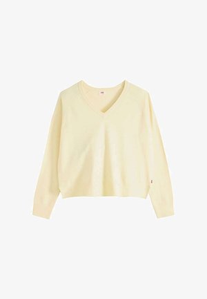 Suéter de manga larga color crema con escote en V, puños acanalados y un ajuste ligeramente corto y relajado.