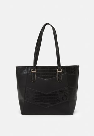 Bolsa tote negra con un patrón texturizado de cocodrilo, secciones lisas, doble asa y detalles en hardware de tono dorado.