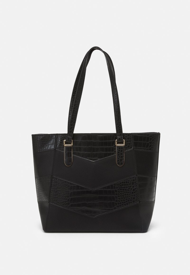 Sac cabas noir avec un motif texturé façon crocodile, sections lisses, double poignée et accents en métal doré.