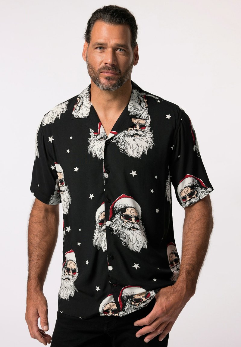 Czarny t-shirt z krótkim rękawem z wzorem czaszki Świętego Mikołaja, zawierającym białe brody i czerwone czapki, akcentowany białymi gwiazdkami. Gładka faktura materiału.