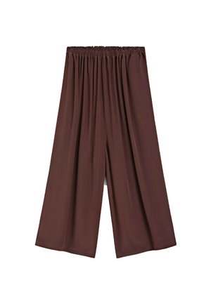 Pantalons larges beige avec une taille élastique, fabriqués en tissu doux, présentant une texture lisse et un design fluide.
