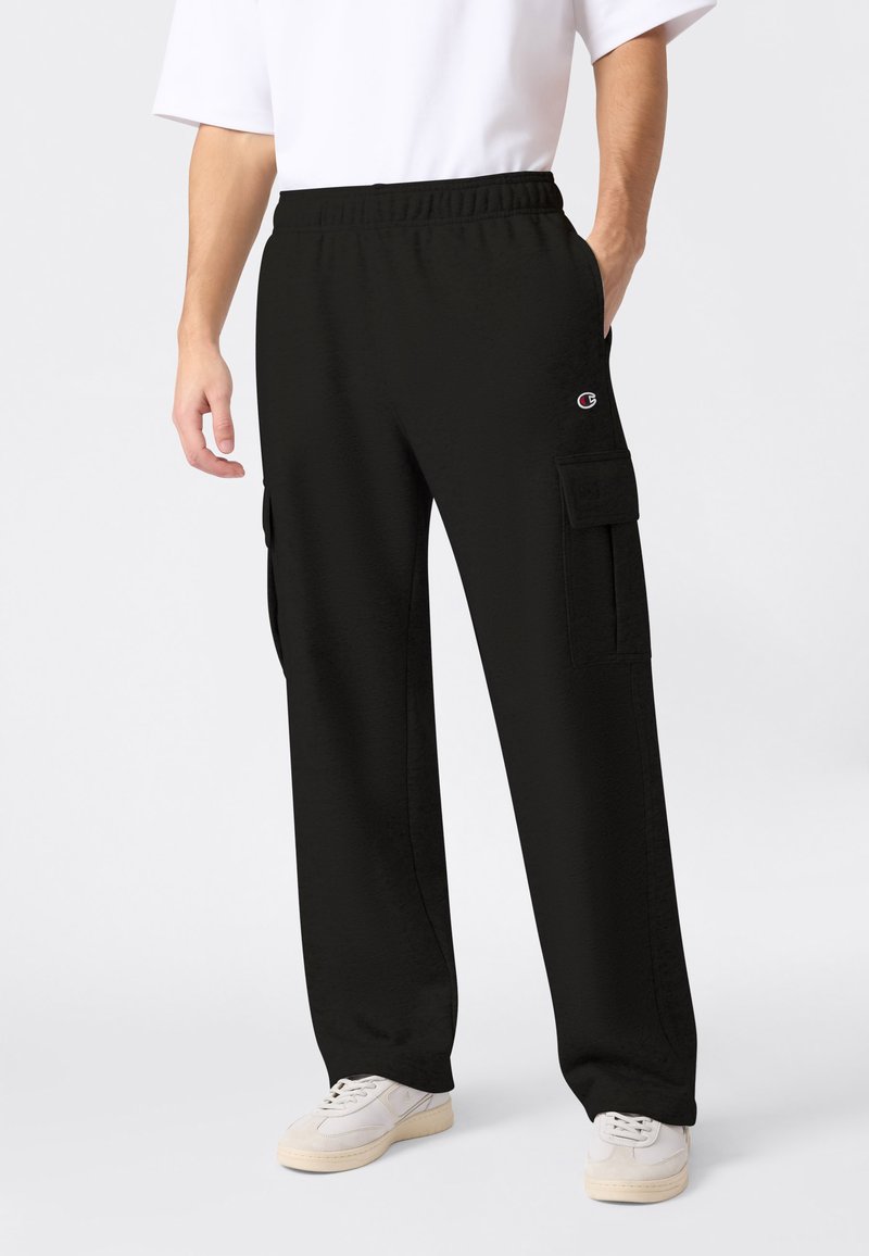 Pantalon cargo noir avec une taille élastique, des poches latérales, et un petit logo. Confectionné dans un tissu doux avec une coupe droite.