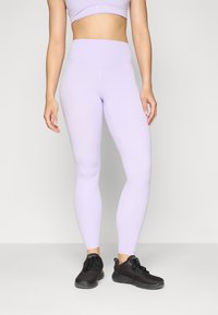 Light purple leggings with a high waistband, smooth texture, and a fitted design. Worn with black athletic shoes.