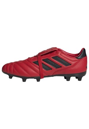 Rote Fußballschuhe mit einem strukturierten Lederobermaterial, ausgestattet mit schwarzen Akzenten und drei schwarzen Streifen, entwickelt für Traktion mit einer genoppten Außensohle.