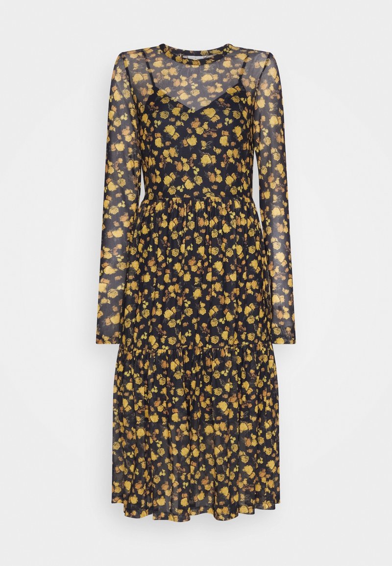 Robe midi noire à manches longues avec superposition transparente et motif floral jaune, taille cintrée et jupe à volants.