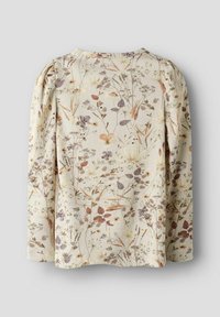 Langärmliges Oberteil in hellem Creme mit floralem Druck in erdigen Tönen. Verfügt über einen strukturierten Stoff und geflochtene Schultern für zusätzliche Details.