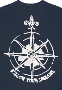 Felpa navy con design a ricamo bianco a forma di bussola, con un fiore centrale e il testo "SEGUI I TUOI SOGNI" in basso.