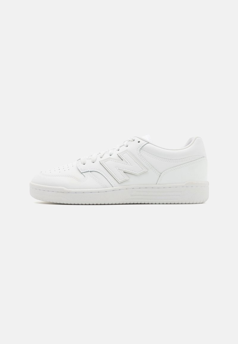 White sneaker made of smooth leather, featuring perforated toe, a textured rubber sole, flat laces, and a prominent 'N' logo on the side.