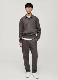 Brown pullover sweatshirt with a collar, paired with matching pants. The outfit features a textured fabric and white sneakers.