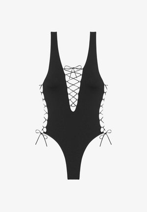 Zwarte badpak met een diepe V-hals, veterfrontend en zijstrikjes. Gladde stof met uitsparingen aan de zijkanten.