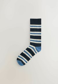 Navy blue sock with horizontal stripes in light blue and cream. Features a solid dark blue cuff and a blue toe. Made of soft material.