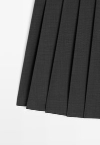 Dark gray pleated skirt made of textured fabric, featuring sharp, even pleats and a hem that finishes below the knee.