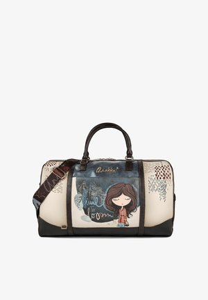 Borsa sportiva color crema e nera con illustrazione di una ragazza dei cartoni animati, manici scuri e tracolla staccabile con motivi decorativi ricamati.