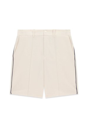 Cream-colored textured shorts with front pleats, side pockets, belt loops, and black piping along the outer seams.