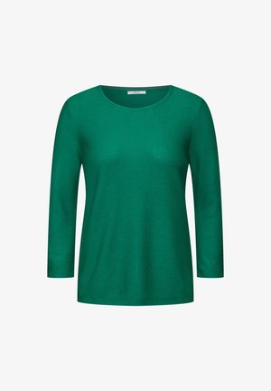 Zielona bluzka z długim rękawem i okrągłym dekoltem, wykonana z fakturowanej tkaniny, o luźnym kroju i minimalistycznym designie.