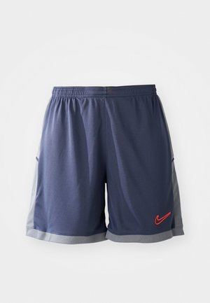 Men's athletic shorts, navy blue fabric with mesh gray side panels, elastic waistband, contrasting red logo on lower left side.