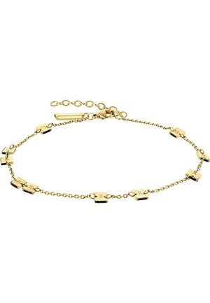 Bracelet chaîne en or avec des maillons espacés en forme de lettres formant le mot "GUESS" sur un fond blanc, équipé d'un fermoir et d'un prolongateur réglable.