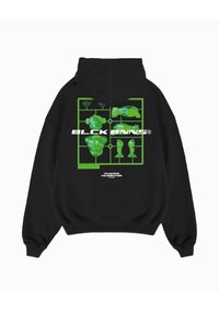 Zwarte hoodie met een groene grafiek op de achterkant, waarop speelgoedcomponenten in een raster zijn afgebeeld, met de teksten "BLCK BNNS" en "TRANSFORM THE GENERATION".