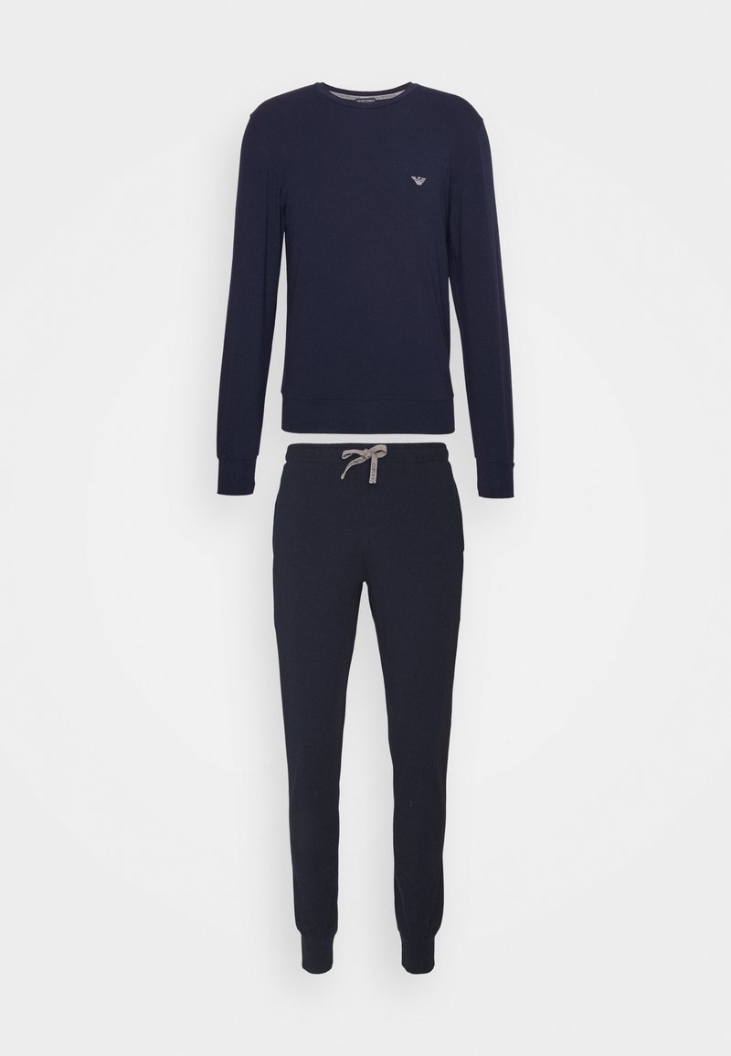 Navy sweatshirt with long sleeves and ribbed cuffs, paired with matching tapered sweatpants featuring an elastic waist and drawstring.