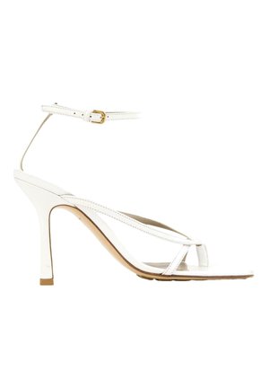 White high-heeled sandal with thin straps, ankle buckle, open toe, and a slender heel, shown from the side.