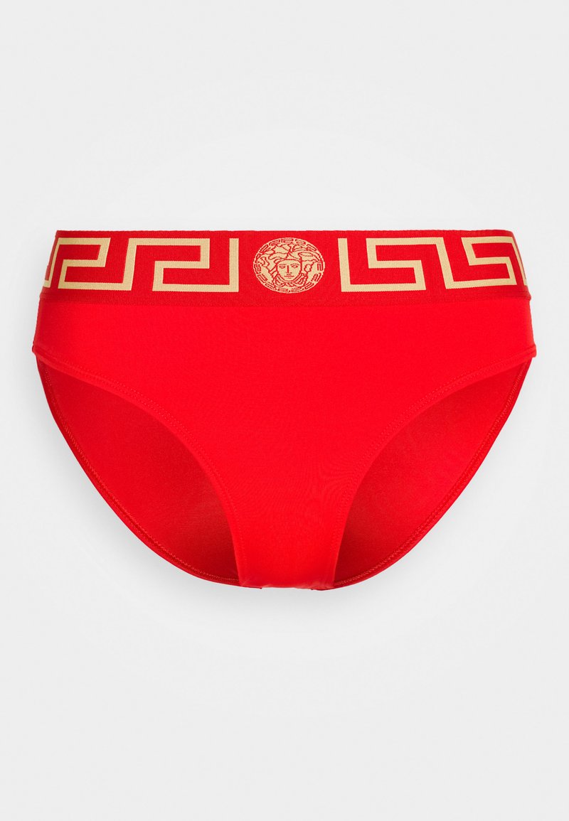 Red bikini bottom with a gold logo waistband featuring a Greek key pattern and a central emblem. Made from smooth, stretchy material.