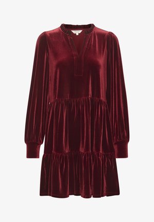 Sügavast burgundispunast sametkleit pikkade puffvarrukatega, lõhiku kaeluse ja kihilise pitsäärisega. Pehme tekstuur ja voolav siluett.