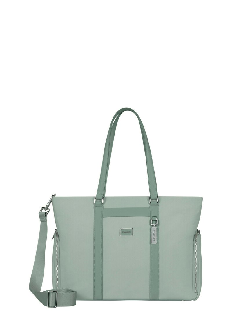 Green fabric tote bag with dual handles and adjustable shoulder strap. Features zippered sides and a front pocket with logo accent.