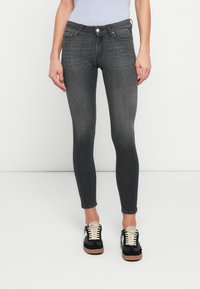 Dark gray skinny jeans made of denim, featuring a five-pocket design, slight fading, and a secure button closure at the waist.