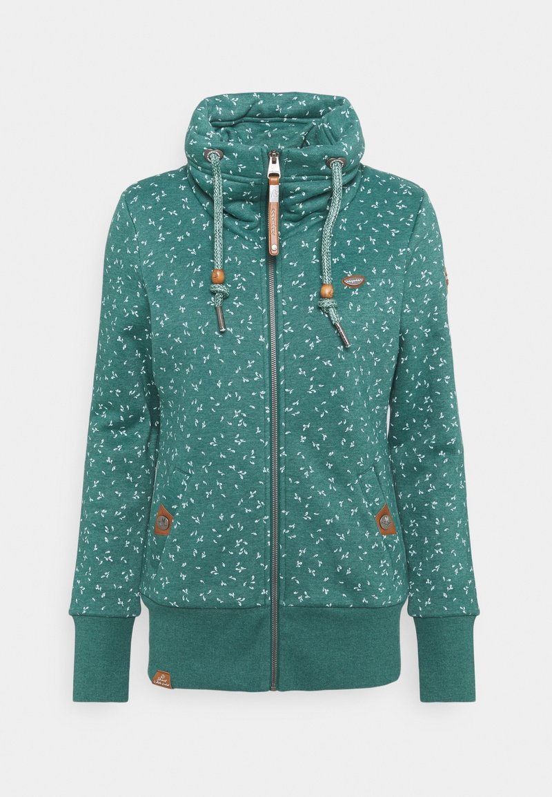 Felpa verde con un motivo floreale, colletto alto, chiusura con zip, coulisse regolabili con dettagli in legno e tasche laterali con zip.