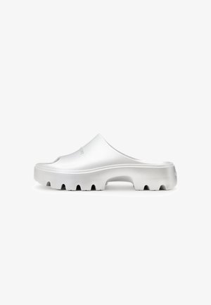 Silver slip-on clogs with a contoured upper, textured finish, and thick, ridged sole. Features a smooth, minimalist design without fastenings.