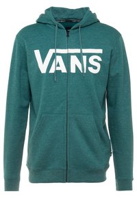 Felpa con zip color turchese realizzata in tessuto morbido, con il logo bianco "VANS" sul davanti, due tasche frontali e cappuccio con cordino.