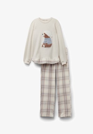 Krémová mikina s výšivkou medvěda s kloboukem, doplněná kostkovanými kalhotami v béžových, modrých a hnědých tónech. Měkká, texturovaná tkanina.