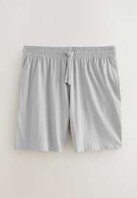 Lichtgrijze shorts van zacht materiaal, met een elastische tailleband en een trekkoord, en zijzakken. Eenvoudige, klassieke snit zonder patronen.