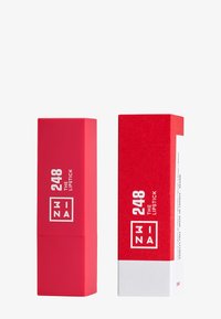 Red lipstick packaging featuring a matte, rectangular casing with white text. Includes a matching red box with white accents and details.