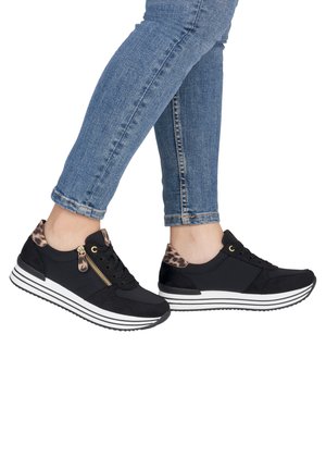 Black athletic shoes with a textured upper, leopard print accents at the heel, gold zip detail, and white striped sole.