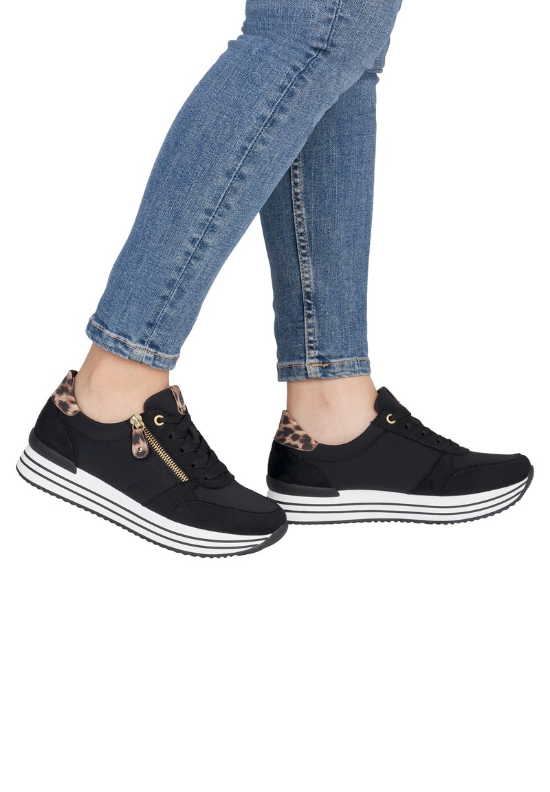 Black athletic shoes with a textured upper, leopard print accents at the heel, gold zip detail, and white striped sole.